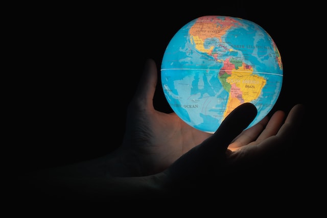 hand holding lit globe